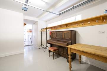 The garage with piano and pool table leads to the utility-area which is a perfect place to store your bicycles!
