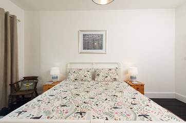 Relax in the main bedroom, complete with original wooden floors.