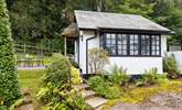 The traditional cottage style windows and the sweetest thatched porch make this little hideaway a picture-perfect haven. - Thumbnail Image