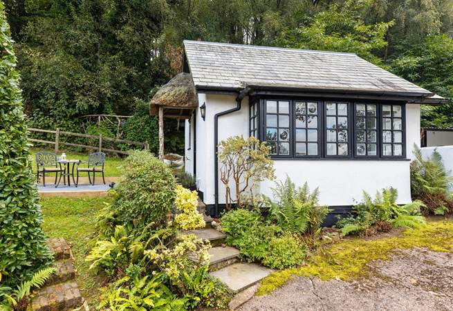 The traditional cottage style windows and the sweetest thatched porch make this little hideaway a picture-perfect haven.