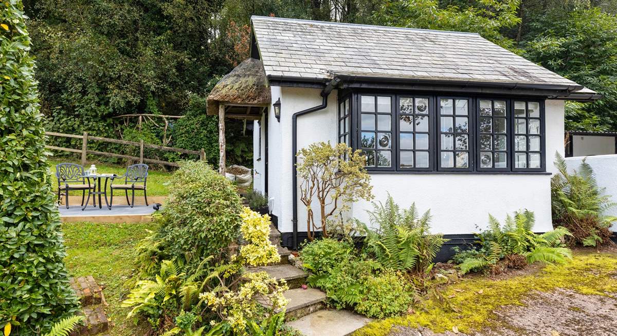 The traditional cottage style windows and the sweetest thatched porch make this little hideaway a picture-perfect haven.