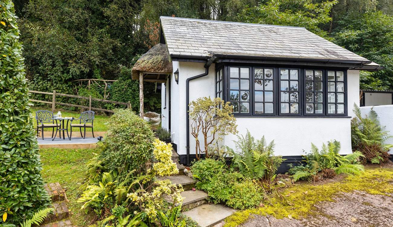 The traditional cottage style windows and the sweetest thatched porch make this little hideaway a picture-perfect haven.