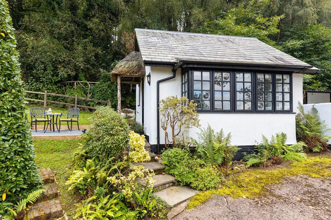 The traditional cottage style windows and the sweetest thatched porch make this little hideaway a picture-perfect haven.