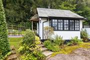 The traditional cottage style windows and the sweetest thatched porch make this little hideaway a picture-perfect haven.