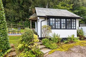The traditional cottage style windows and the sweetest thatched porch make this little hideaway a picture-perfect haven.