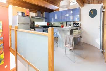 The stairs lead into the kitchen/dining area.