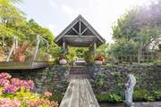 Following the walkway up and over the stream into the upper garden area.