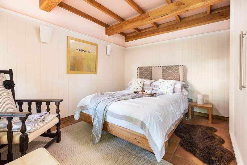The bedroom is super inviting. What a lovely room to retire to following a day of adventure.
