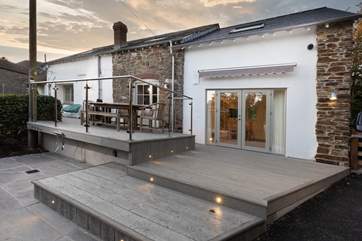 The kitchen opens up onto this subtly lit decked area. Great for enjoying an evening watching the sun go down whilst the little ones play in the garden.