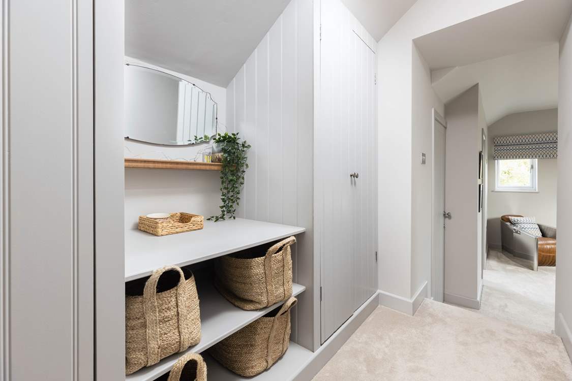 Bedroom three has its very own dressing area with oodles of storage space. Please note the step down into the bedroom area.