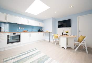 A wonderful cosy open plan living-room with kitchen and dining areas.