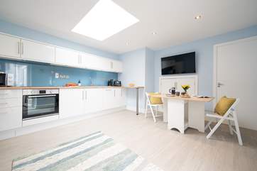A wonderful cosy open plan living-room with kitchen and dining areas.