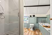 The family bathroom offers you the choice of a refreshing shower or a leisurely soak in the tub.