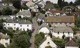 An aerial shot of Holcombe showcases the array of beautiful thatched houses, a pretty central church, and at the heart of the village, the welcoming village pub at the top of the road. - Thumbnail Image