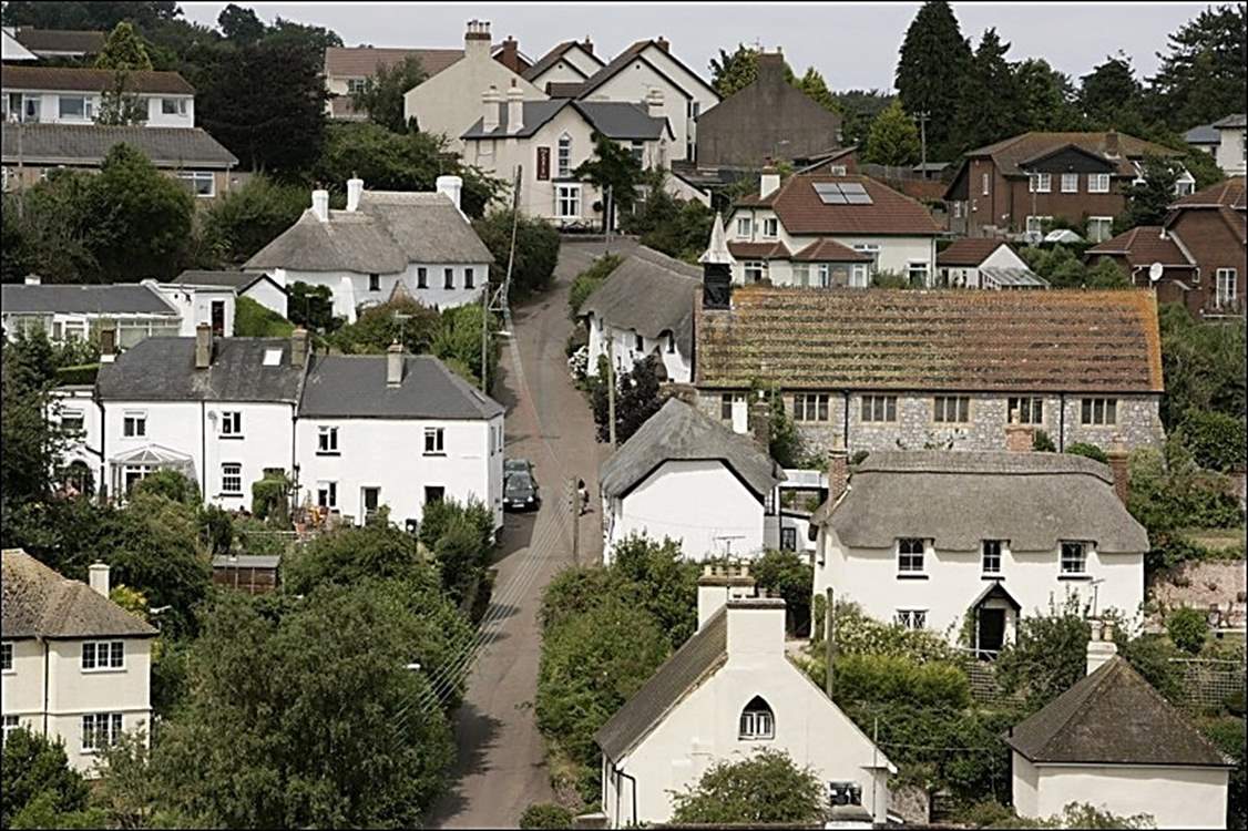 An aerial shot of Holcombe showcases the array of beautiful thatched houses, a pretty central church, and at the heart of the village, the welcoming village pub at the top of the road.