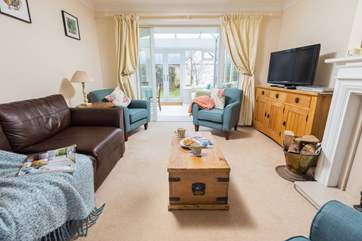 Kick back and relax in the cosy sitting-room that leads on to the conservatory.