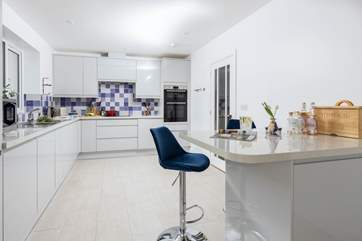 The light and modern kitchen has everything you might need for a culinary feast.