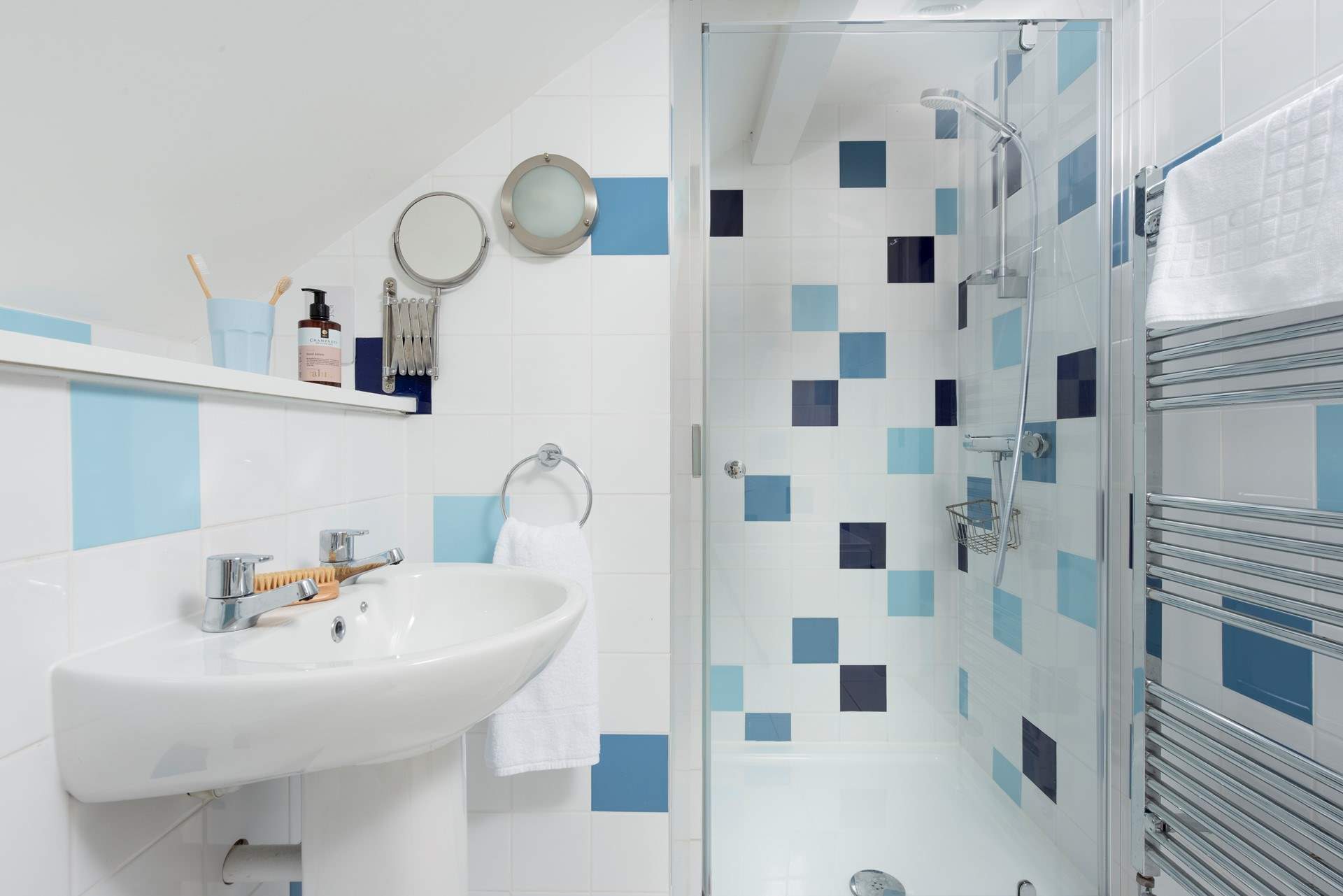 The family bathroom on the first floor has a shower and heated towel rail.