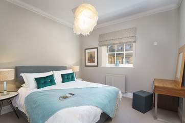 This bedroom is complete with dressing table, fitted wardrobes and courtyard views.