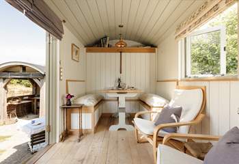 The fold-down table and seating area provide the perfect spot for slow breakfasts or relaxed evening meals.