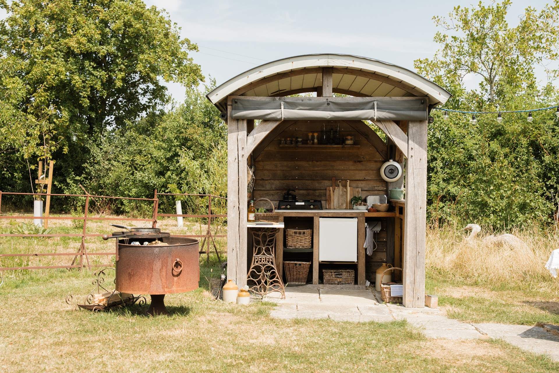 Cleverly designed with pull down sides for cooking during all seasons.