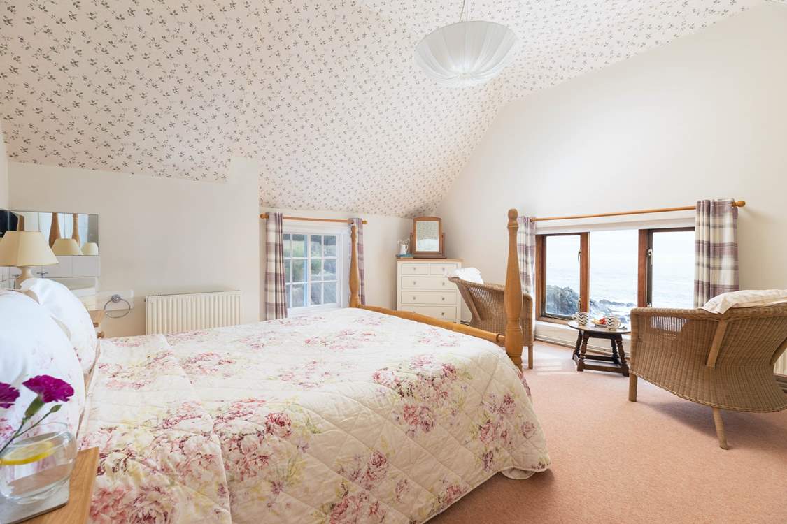 Lie in bed in the main bedroom and gaze out to sea.