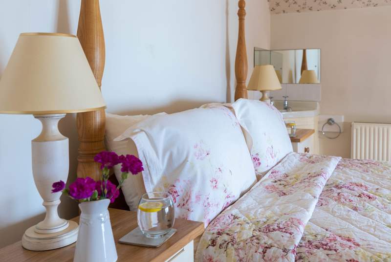 The main bedroom has pretty floral linen, lie in bed and gaze out to sea. 