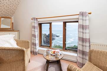 Enjoy a quiet moment in the main bedroom with your morning cup of coffee.
