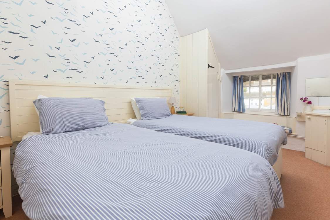 The twin bedroom has views over the pretty village.