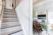 The steep central staircase leads up to the bedrooms, family bathroom, games-room and top terrace. Please watch your head at the bottom of the stairs.