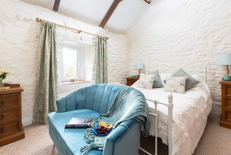 The charming double bedroom has characterful exposed beams and original brickwork.
