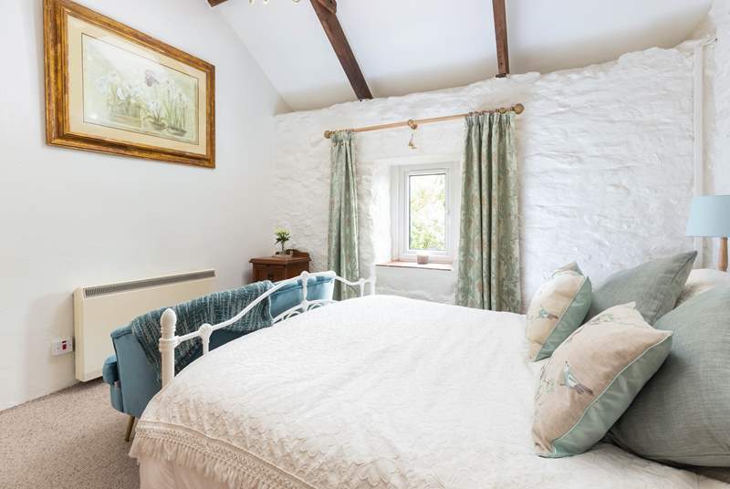 The charming double bedroom has a comfy king-size bed.