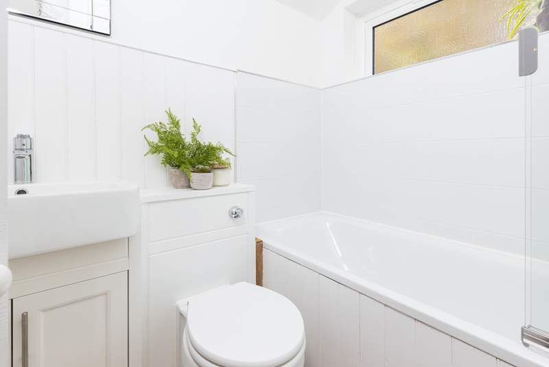 The sleek newly refurbished family bathroom. Enjoy a quick shower or a leisurely soak in the bath.
