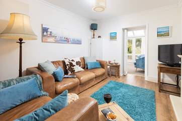 The cosy sitting room leads to the lovely conservatory.