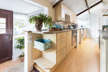 The galley kitchen has all you need for creating a holiday feast (please watch your step from the entrance hall).