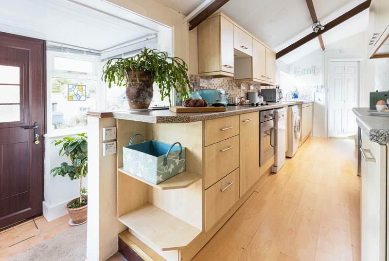 The galley kitchen has all you need for creating a holiday feast  (please watch your step from the entrance hall). 