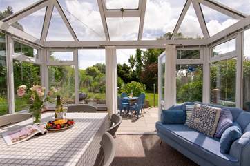 The comfy sofa in the conservatory is the perfect spot for a holiday read.