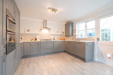 The sleek and stylish modern kitchen has access to the sunny conservatory.