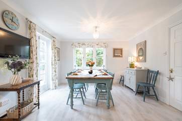 The welcoming open plan kitchen with an inviting dining area is light and spacious.