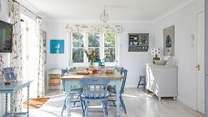 The welcoming open plan kitchen with an inviting dining-area is light and spacious.