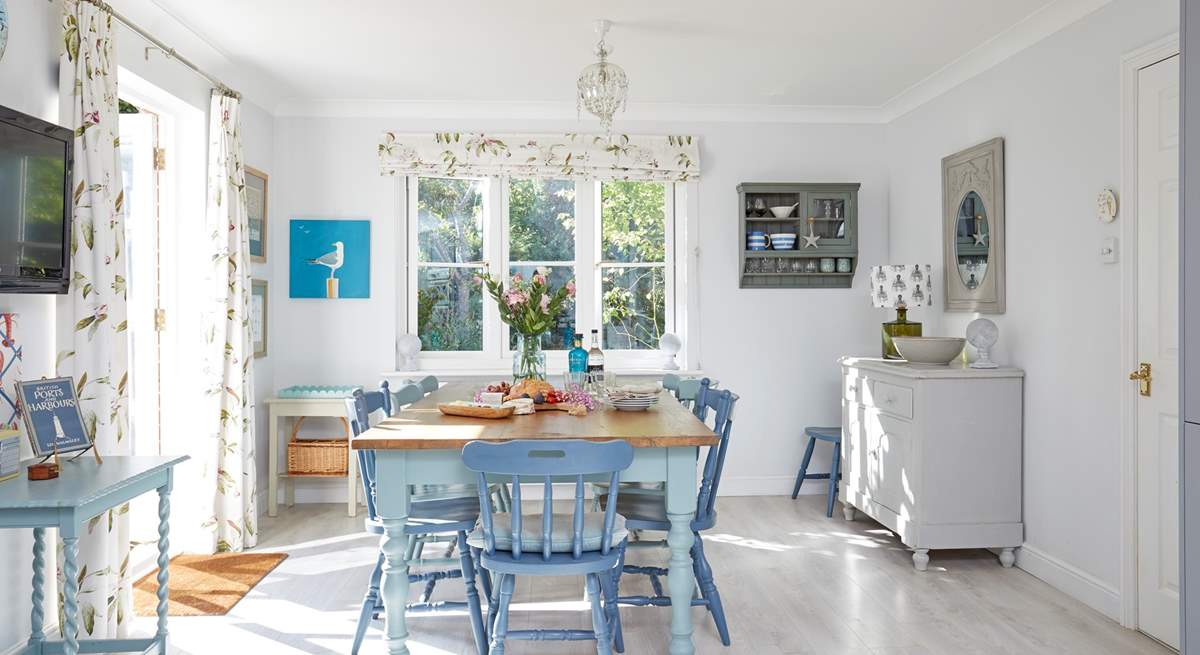 The welcoming open plan kitchen with an inviting dining area is light and spacious.