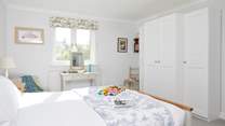 The lovely main bedroom overlooks the garden.