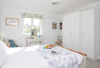 The lovely main bedroom overlooks the garden.