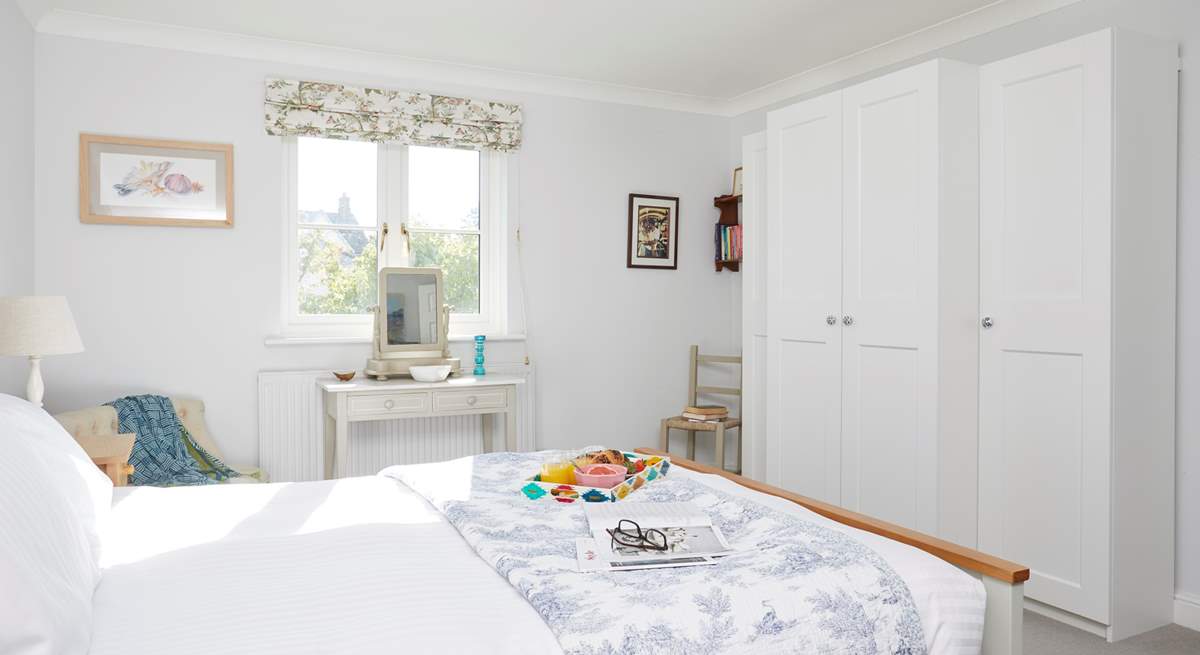 The lovely main bedroom overlooks the garden.