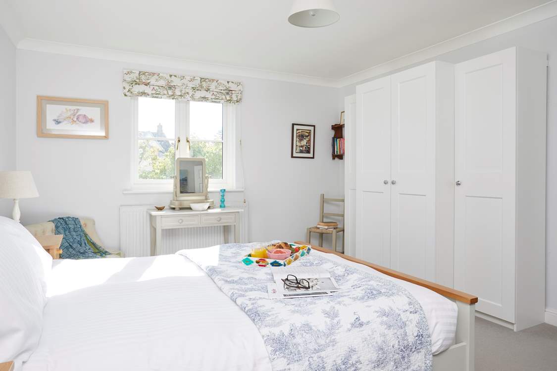 The lovely main bedroom overlooks the garden.