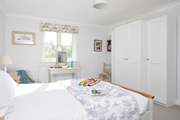 The lovely main bedroom overlooks the garden.