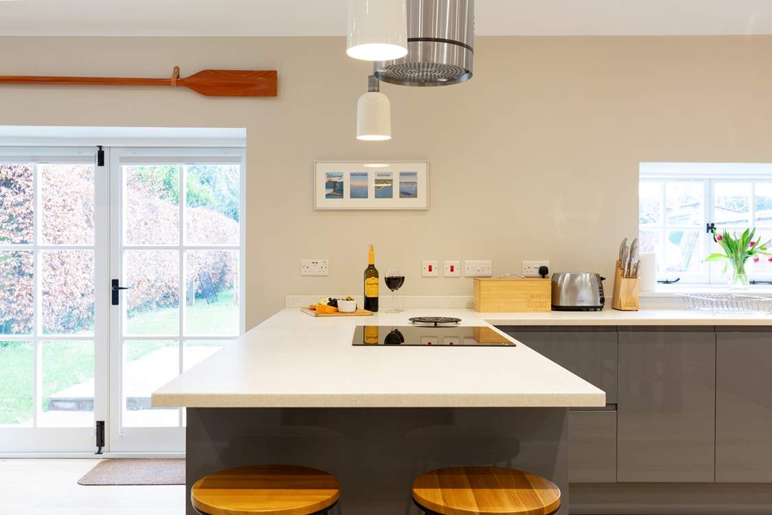 The kitchen has plenty of work surface to prepare a meal. Double doors lead to the garden.