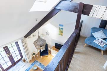 The light mezzanine overlooks the pretty sitting-room.