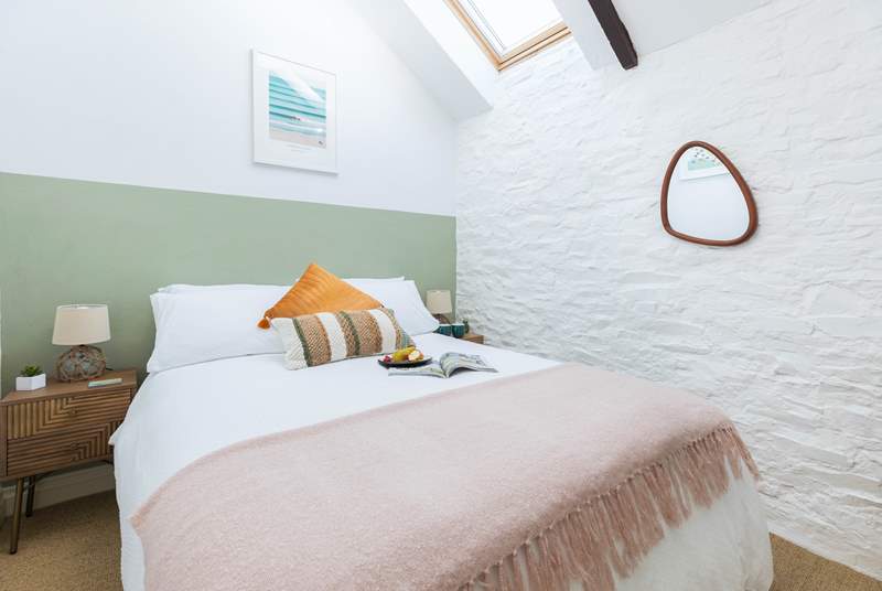 Light filled and beautifully decorated, the double bedroom with characterful beams is charming.