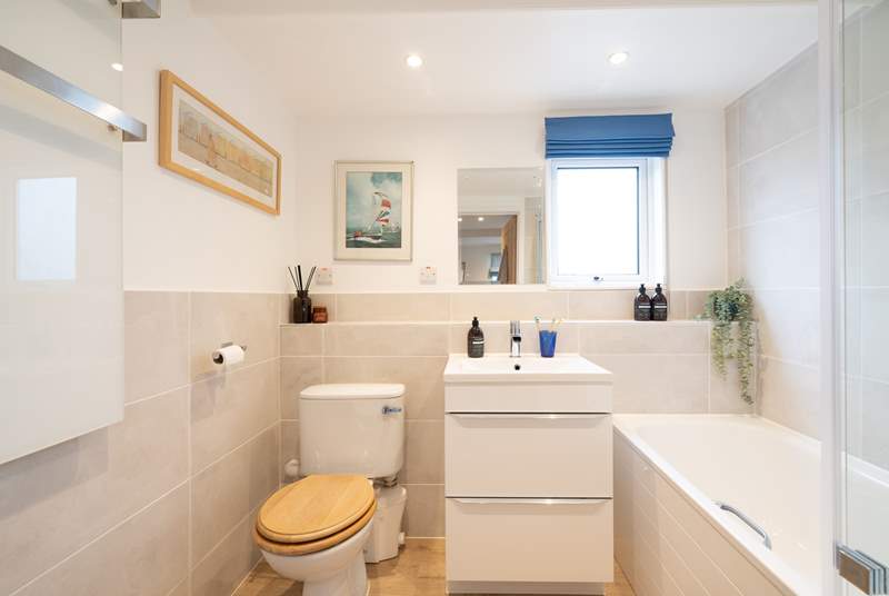 The family bathroom has a bath with shower over, ideal for a long soak after a busy day.